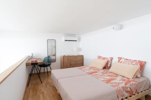 a bedroom with a bed and a desk and a mirror at Lixouri Square Loft in Lixouri