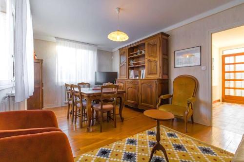 a living room with a table and chairs at Sweet Villa Burgundy in Dijon