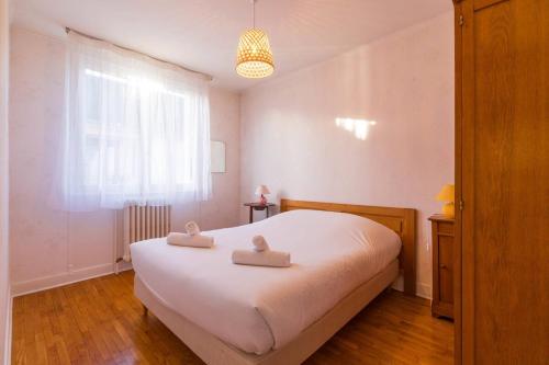 a bedroom with a bed with two towels on it at Sweet Villa Burgundy in Dijon