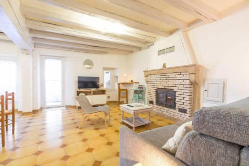 a living room with a couch and a fireplace at La Cabotte d'Ahuy in Ahuy