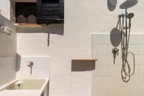 a bathroom with a sink and a shower at Villa Terry in Marongiu