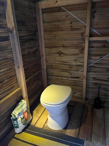 a bathroom with a toilet in a log cabin at Panoramic View - near Pulpit Rock in Strand