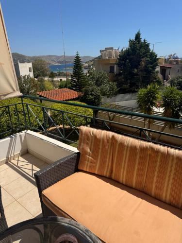 a couch sitting on a balcony with a view at GK23 Sea View House in Anavyssos