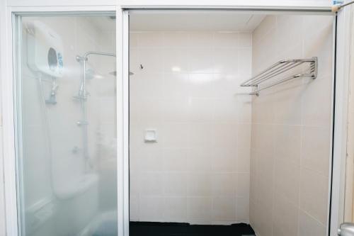 a shower with a glass door in a bathroom at 103 Hotel by manatidur in Kuala Lumpur