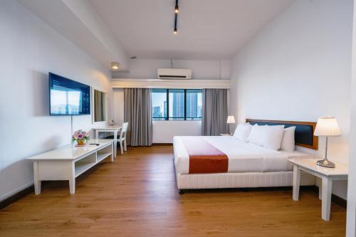 a hotel room with a bed and a desk at 103 Hotel by manatidur in Kuala Lumpur