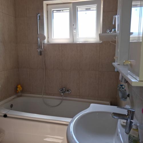a bathroom with a bath tub and a shower at SUNTIME apartament 5 in Kotor