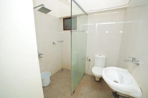 a bathroom with a toilet and a sink and a shower at La PAVI RESORT in Auroville