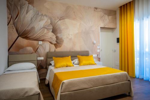 a bedroom with a bed with yellow pillows at Carlo's Luxury Villa in Agerola