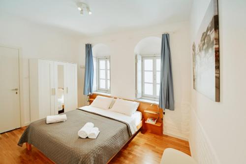 a bedroom with a bed with two towels on it at Hydra's Ruby in Hydra