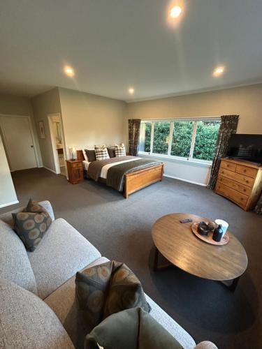 a large living room with a bed and a table at Amberley Lodge in Amberley