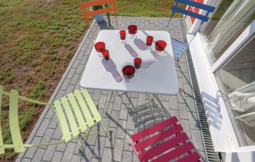 a table with wine glasses and chairs on a patio at Haus Hallon in Wandlitz