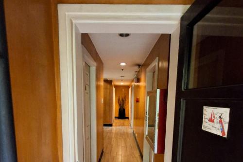 a hallway with a hallway leading into a room with a hallway at Windy Ridge Hotel Malate Manila in Manila