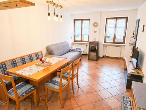a living room with a table and a couch at ElvesHome - Alpine Stay Apartments in Predazzo