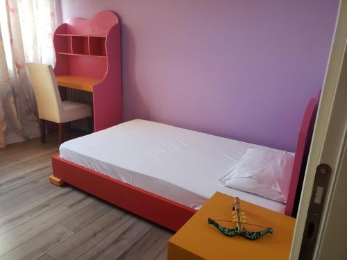 a small bedroom with a bed and a desk at Panoramic Sea View Apartment Saranda in Sarandë