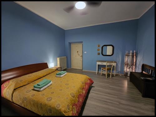 a bedroom with a bed and a blue wall at Narnia e la Rocca di Albornoz in Narni