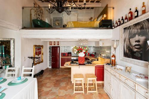 a kitchen with red cabinets and a table with chairs at 2 Bedrooms central Saint-Tropez, next to the Port in Saint-Tropez
