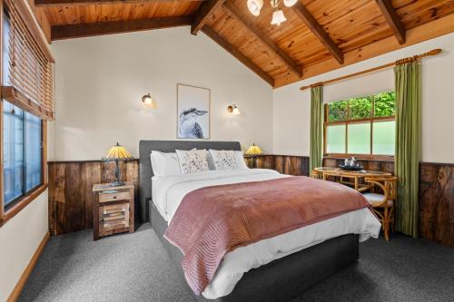 a bedroom with a large bed and a window at Tamborine Mountain Bed and Breakfast in Mount Tamborine