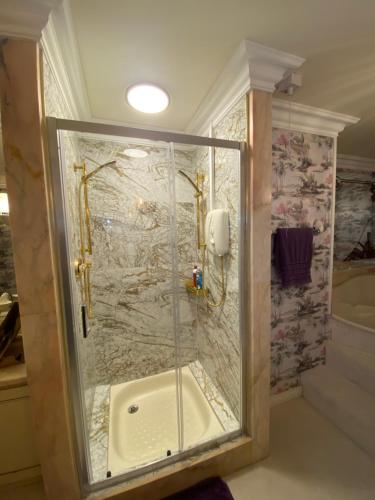 a shower with a glass door in a bathroom at Winterwood in Listowel