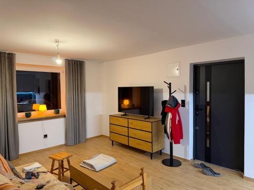 a living room with a couch and a dresser at MAAN Apartments in Augustów