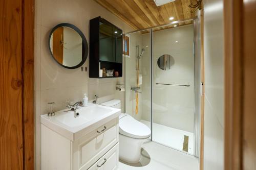 a bathroom with a toilet and a sink and a shower at Hanok Moonstay in Gyeongju