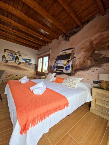 a bedroom with a bed with a race car on the wall at Villa en el Time con piscina in Puerto del Rosario