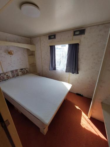 a small room with a bed and a window at Sunny Quiet Nest in Jūrmala