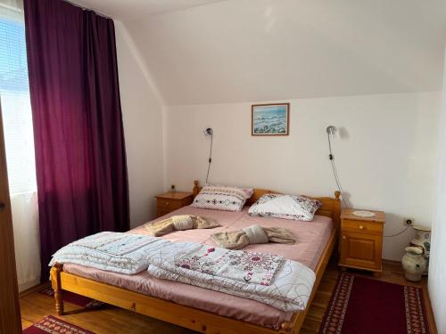 a bedroom with a bed with two pillows on it at Семейна къща Боеви in Pomorie