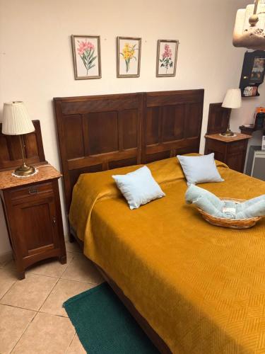 a bedroom with a bed with two pillows on it at Camera Glicine con bagno privato in Castellero