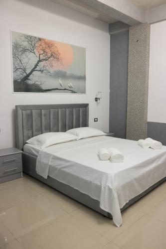 a bedroom with a large bed with white sheets at Ergi Riverside Villas in Zues
