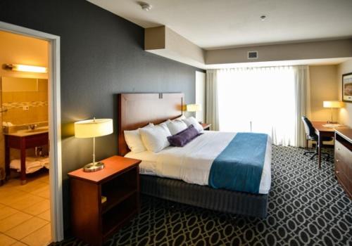 a hotel room with a bed and a bathroom at Bluemont Hotel in Manhattan