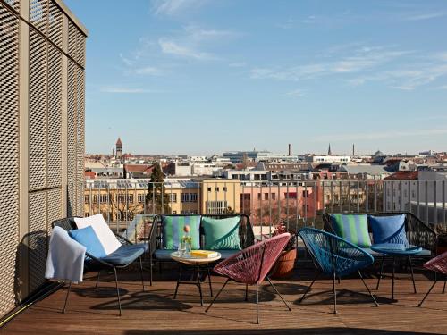 a group of chairs and a table on a balcony at Numa Berlin Weinmeister in Berlin