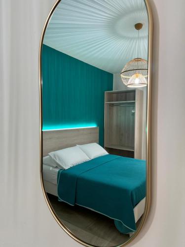 a bedroom with a bed and a mirror at Stefanelli Tropea Home in Tropea