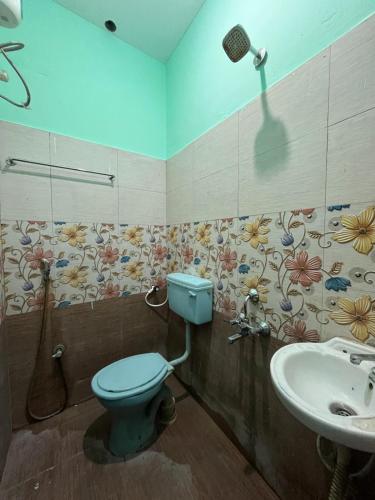 a bathroom with a blue toilet and a sink at STAR Residency - G in Pondicherry