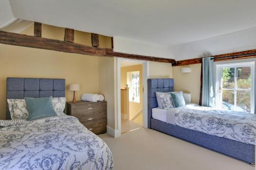 a bedroom with two beds and a window at Finest Retreats - Josua, Maldon in Maldon