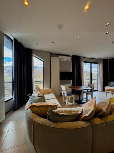 a living room with a couch and a table at Chiko Group in Aspindza