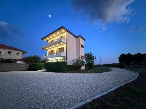 a house with lights on the side of a road at Villa Apollonia Guest House in Fier
