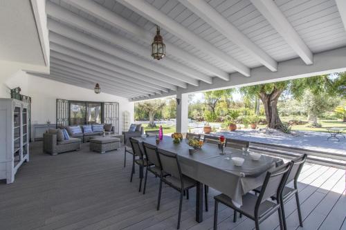 a dining room with a table and chairs on a deck at Villa Isabelle by Algarve Holidays - Loule in Loulé