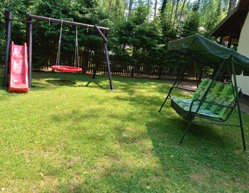 a park with a swing set and a playground at Domek Mazury u Basi in Jerutki