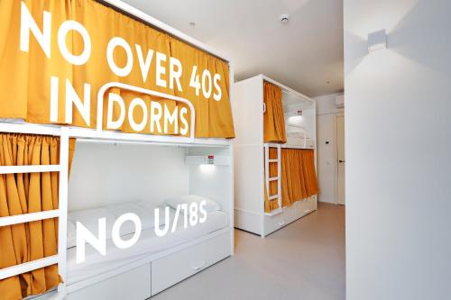 a room with bunk beds and a sign that says no over in donuts at Boavista 83 Hostel Lisbon in Lisbon