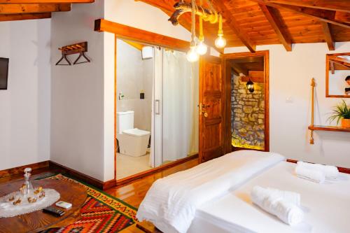 a bedroom with a bed and a bathroom at Anhel Hotel in Berat