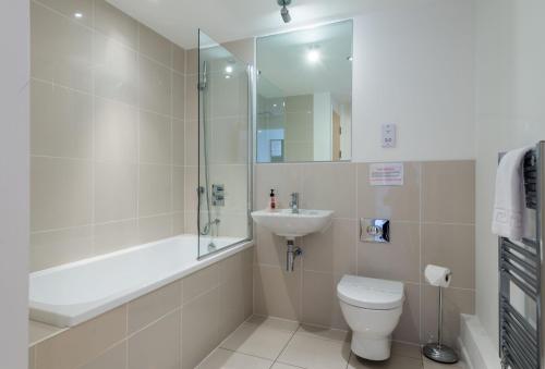 a bathroom with a shower toilet and a sink at 11 Zinc in Newquay in Newquay