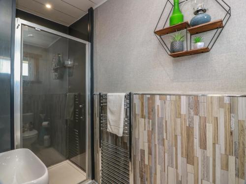 a bathroom with a shower and a sink at Crown Cottage in Dunfermline