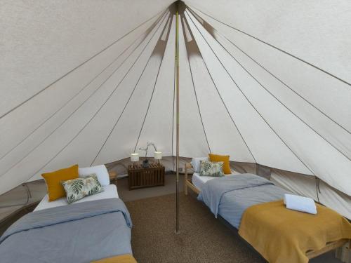 a room with two beds in a tent at Adeje - TwinFin Hostel & Surf Yoga Camp in Callao Salvaje