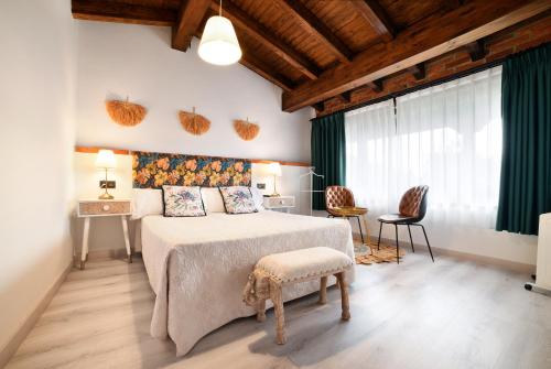 a bedroom with a large bed with green curtains at La Cabaña de La Nina in Beceña