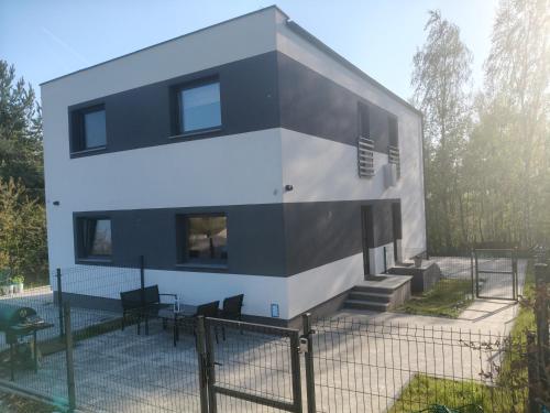 a house with a black and white facade at Apartament Skorochów Jezioro in Skorochow
