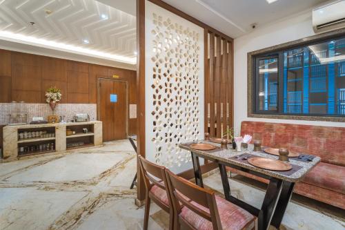 a dining room with a table and chairs at Tripli Hotels Shourya Residency in Udaipur