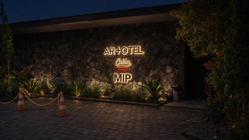 a sign for an autocooco mip on a building at ARTOTEL Cabin Bromo in Bromo