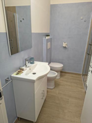 a bathroom with a sink and a toilet and a mirror at NonSoloCitta' in Torrette