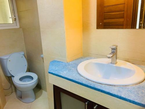 a bathroom with a sink and a toilet at Crystal Sand Mount Lavinia in Mount Lavinia