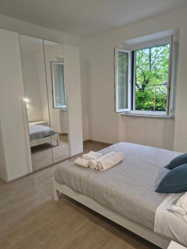 a bedroom with a bed and a large mirror at NonSoloCitta' in Torrette